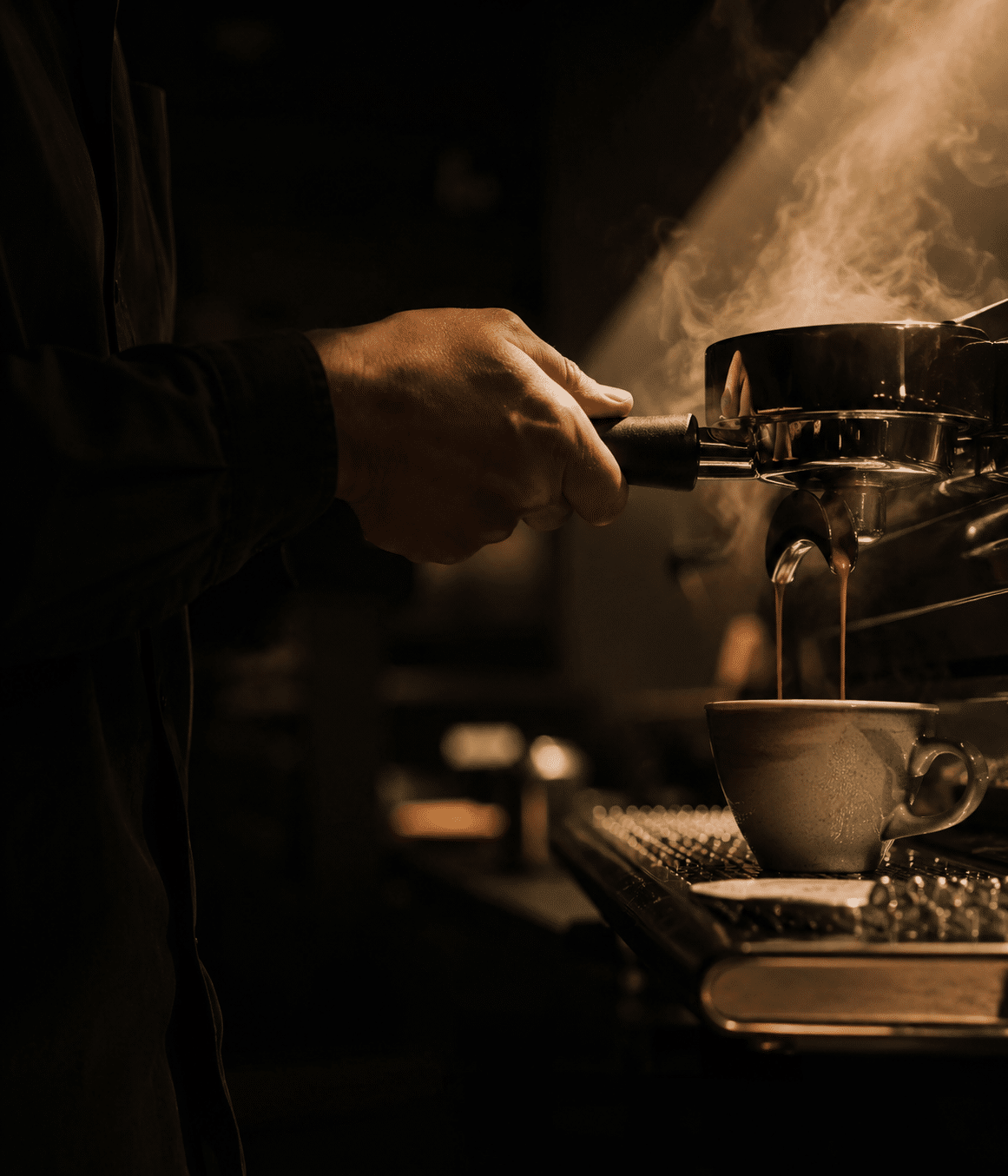 Barista's hands pouring specialty espresso — craft and concentration in coffee service